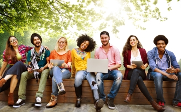 A group of students on a bench in summer