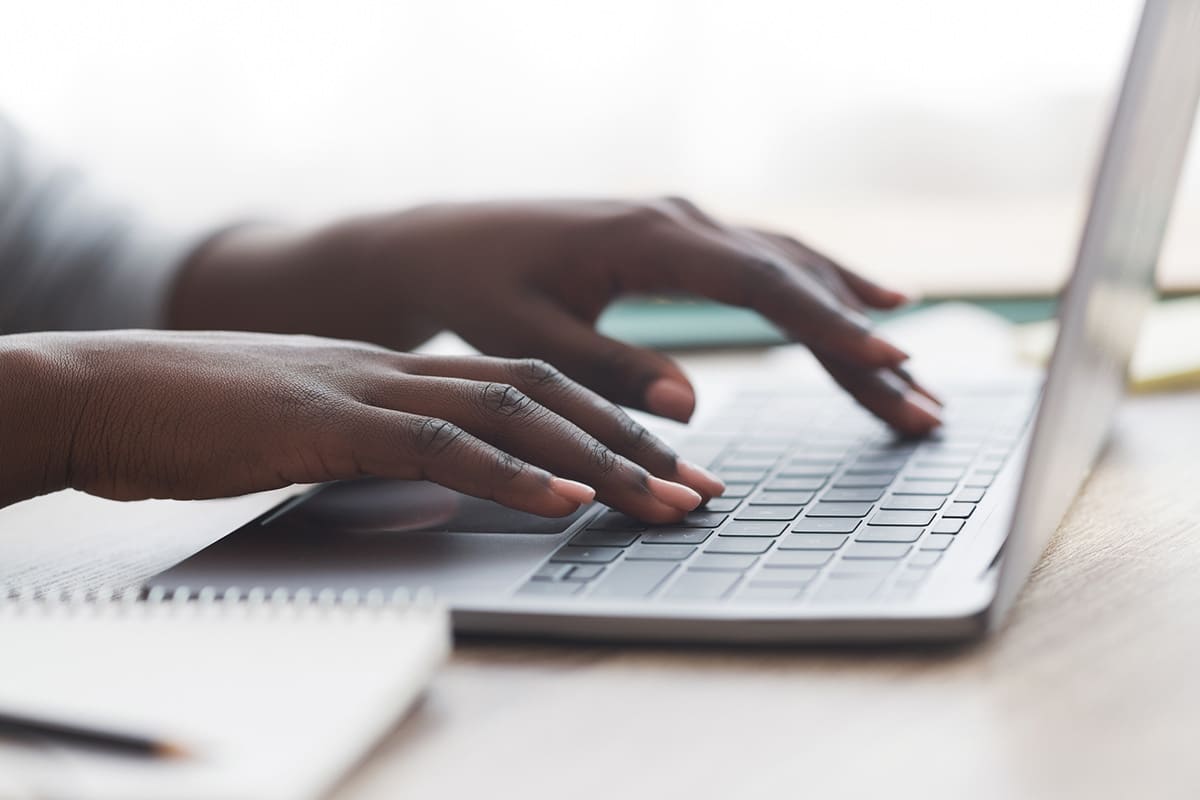 Hands typing on a keyboard