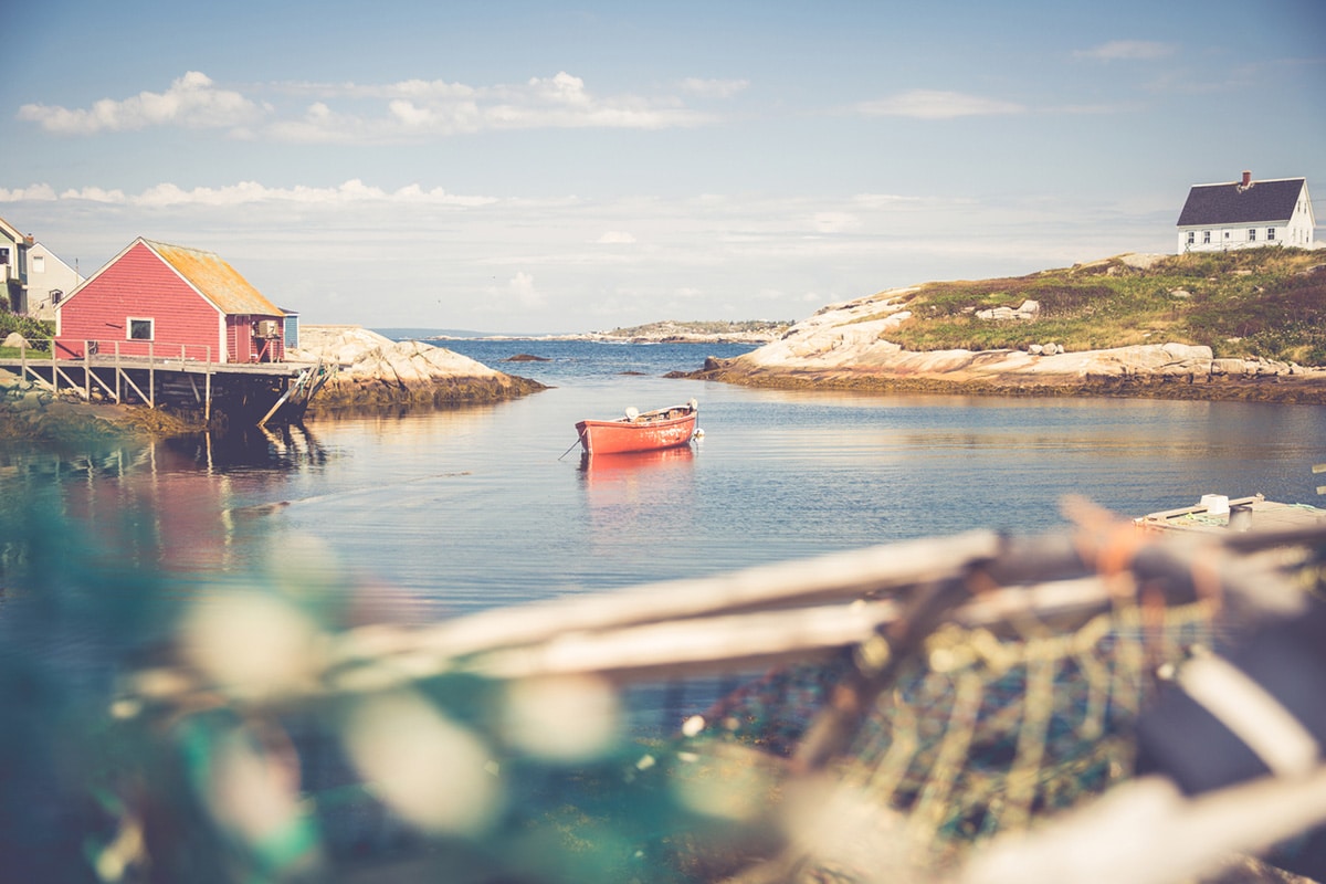 A red canoe anchored in an Eastern Canada bay