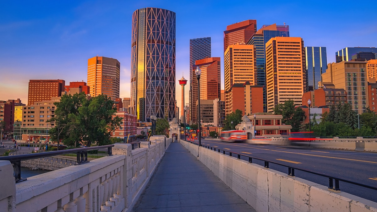 Calgary tower peaking between buildings in Calgary, Alberta.