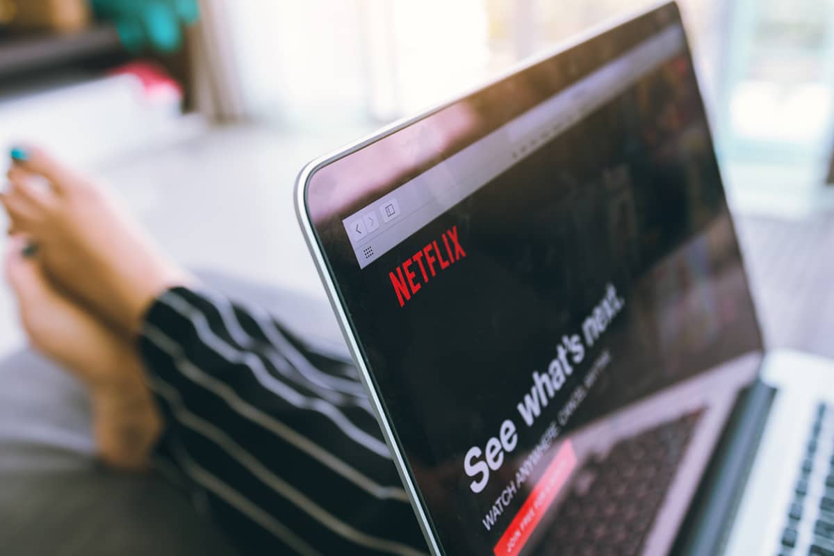 Person watching Netflix on laptop