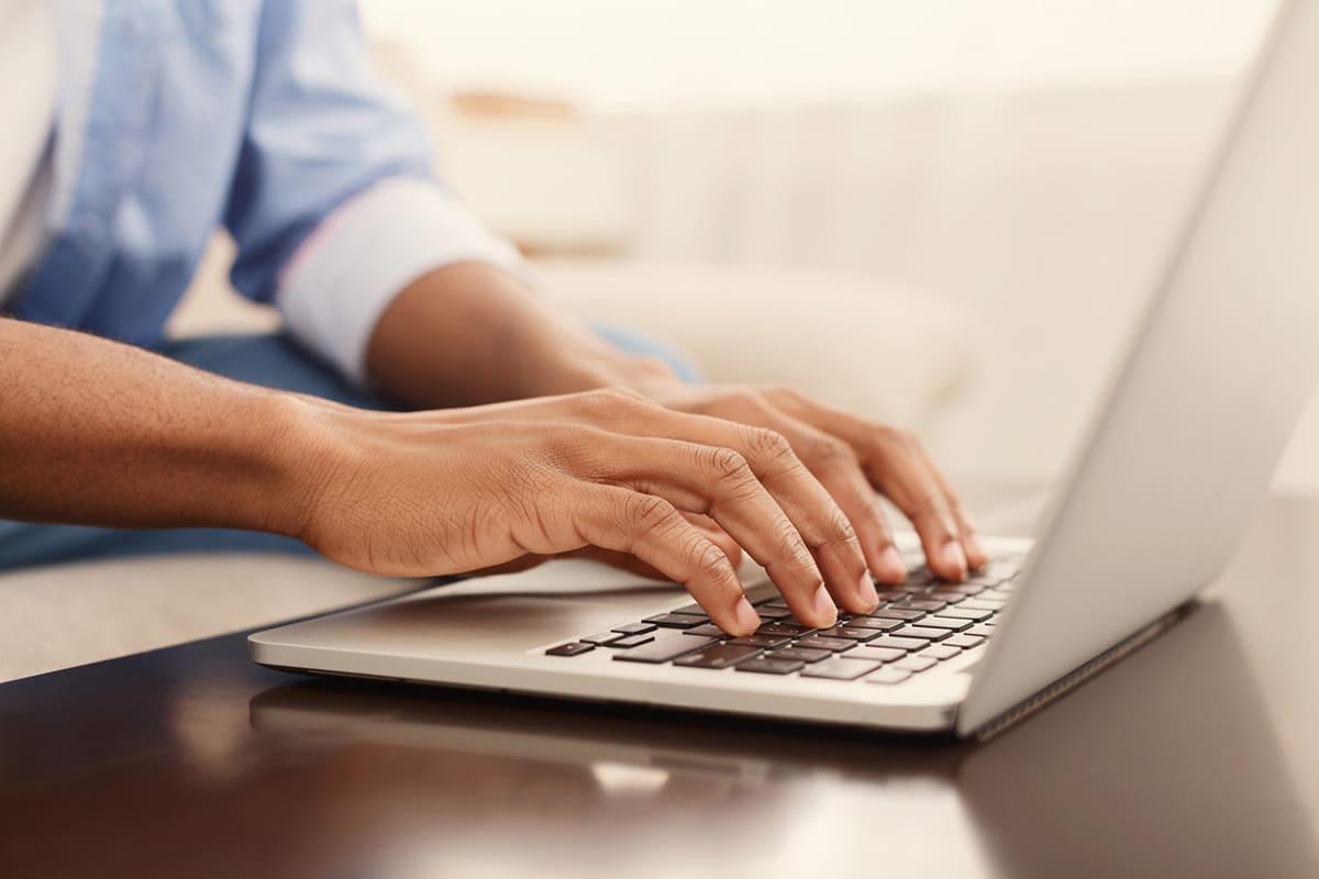 Someone typing on computer
