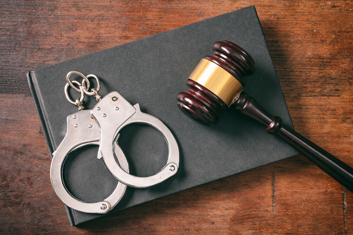hand cuffs and resting on a mallet