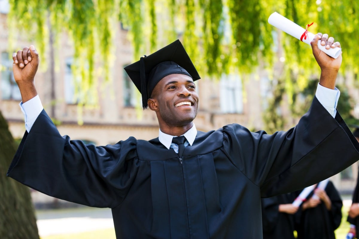 Graduate holding diploma