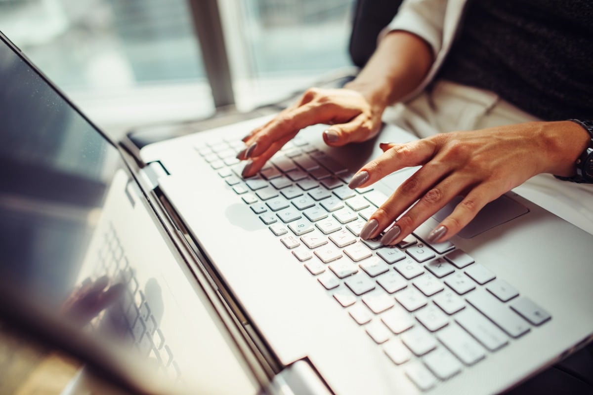 hands typing on a keyboard