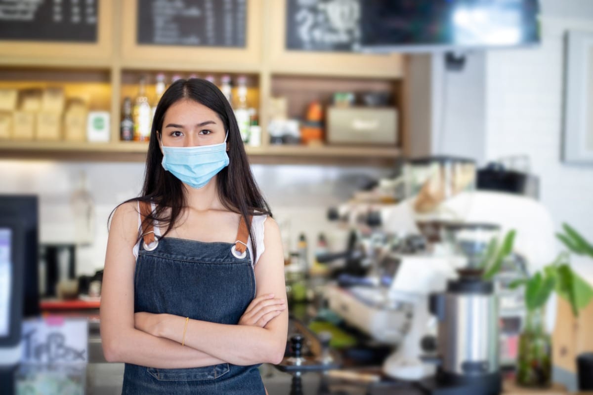 Barista wearing surgical mask.