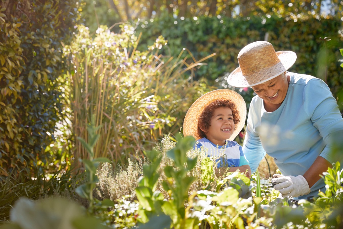 Grandchild and grandmother in a garden