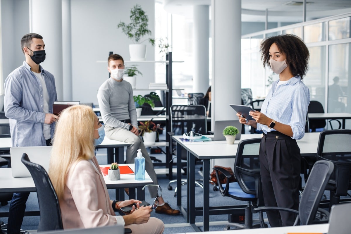 Office meeting where everyone is wearing surgical masks.