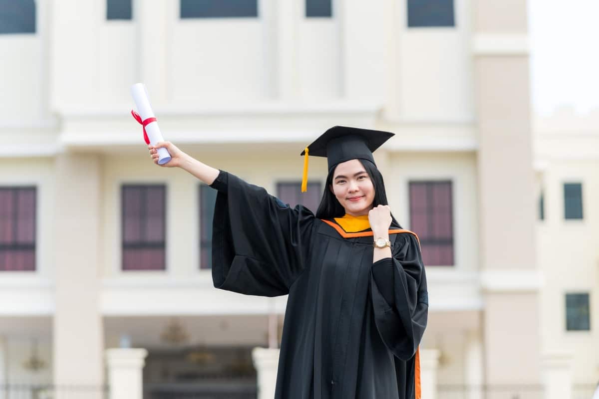 Graduate holds up diploma