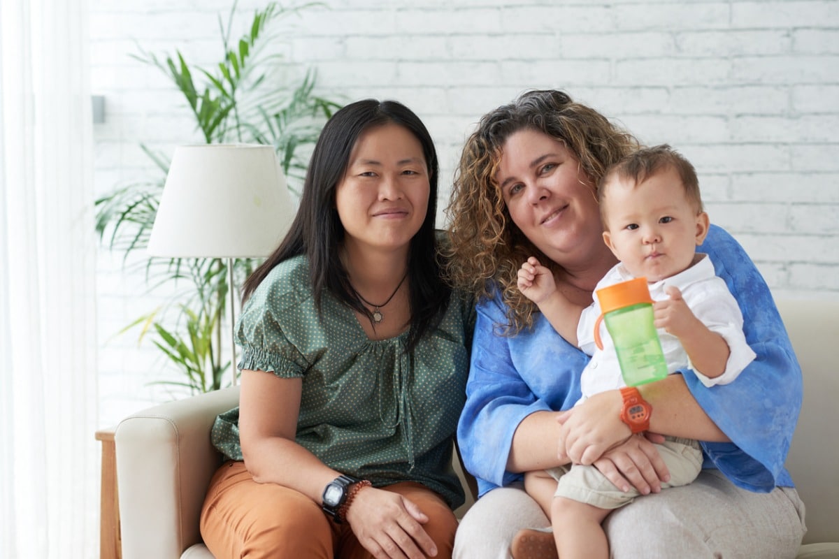 same-sex couple holding baby