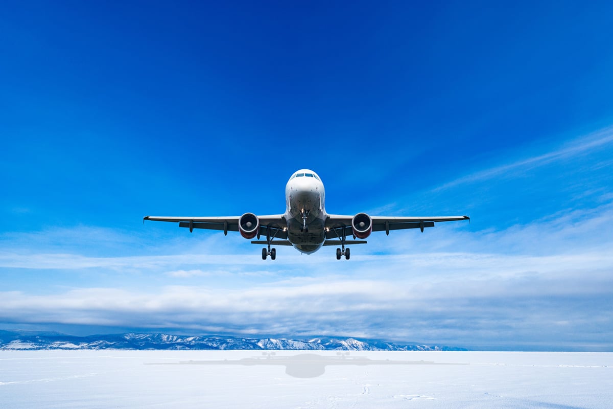 Airplane flying over snow