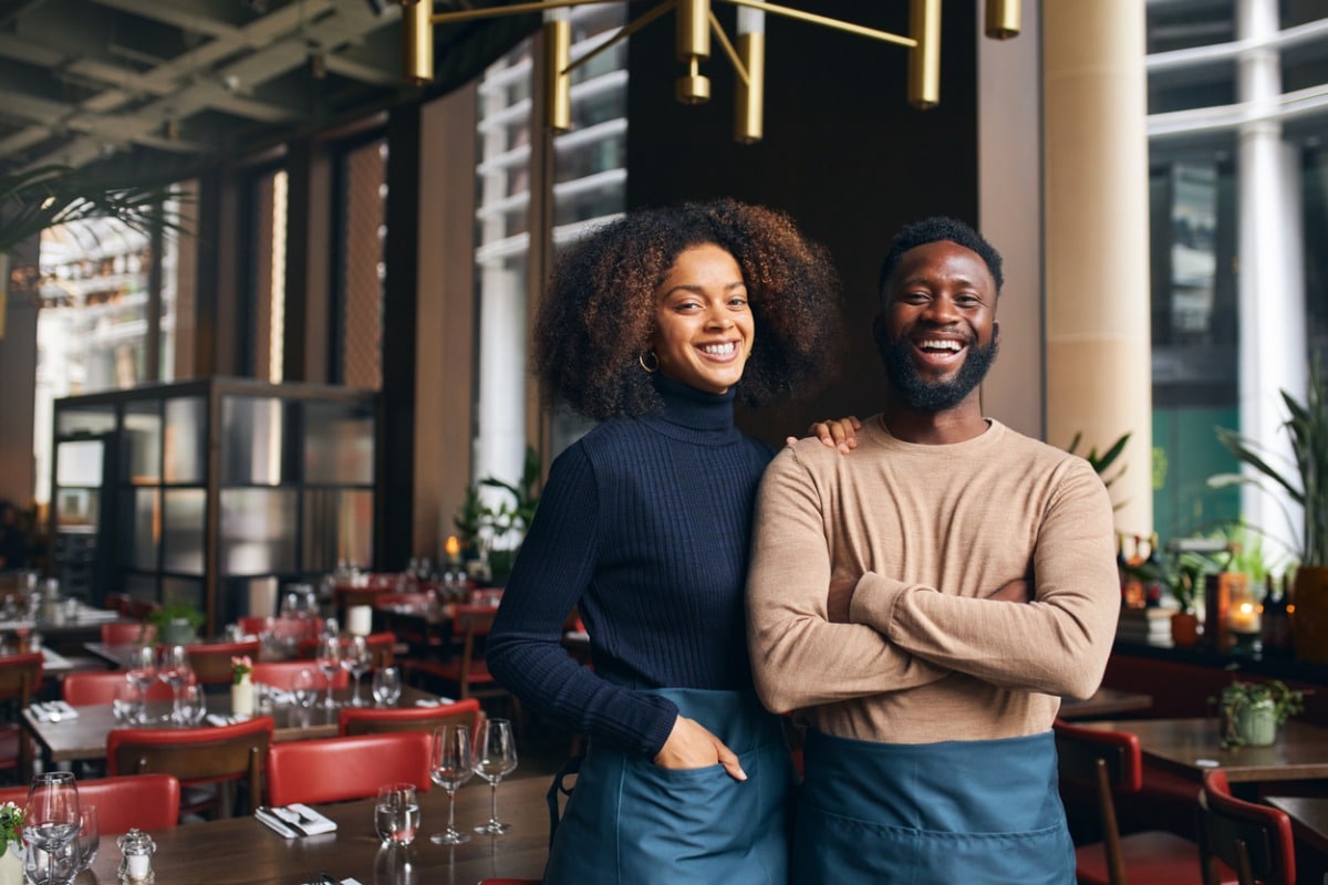 Couple posing at work in restaurant