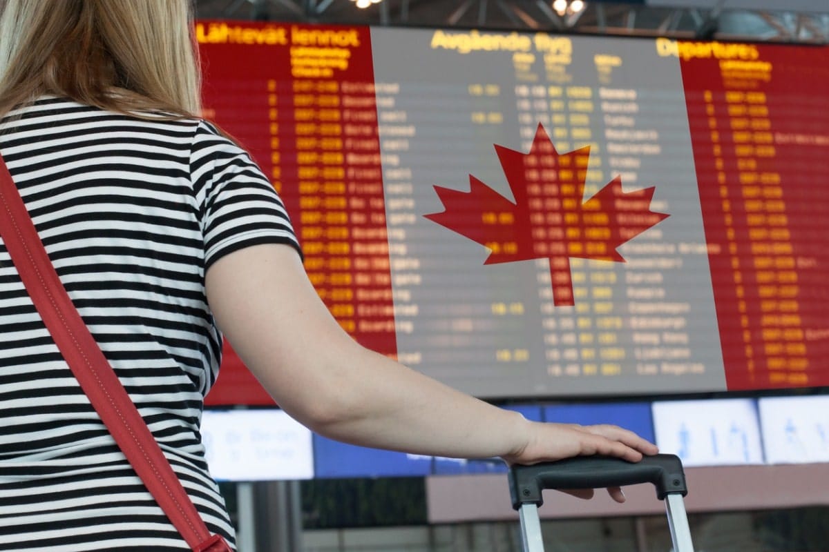 Woman looks at board at airport