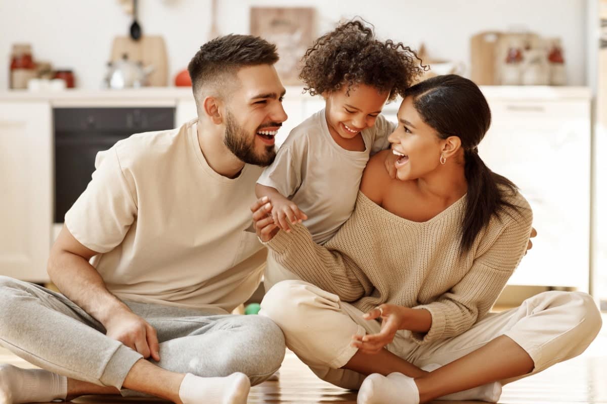 Family hugging daughter