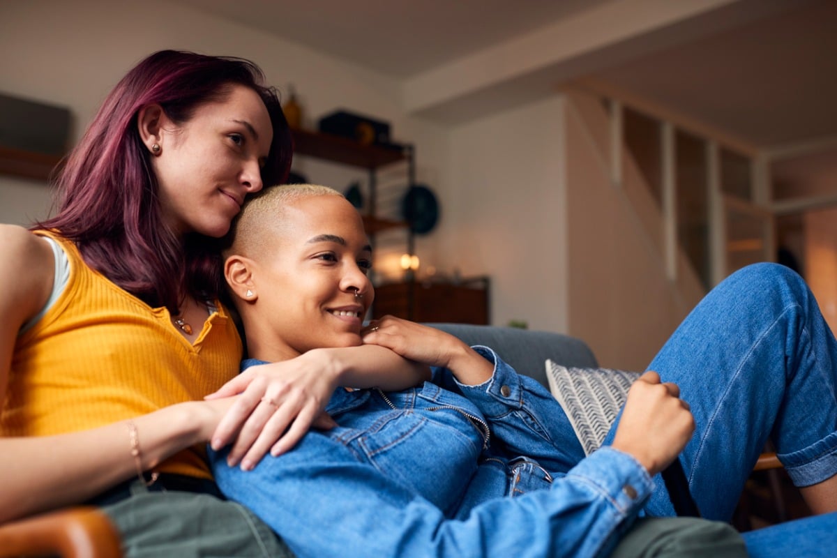 Couple cuddling on the couch.