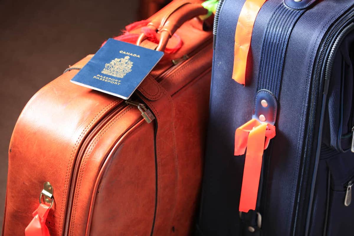 Two suitcases with a Canadian passport on one of them