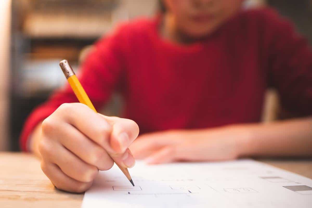 Student writing at a desk. Canada is a hot bed for international students from around the world, for its many