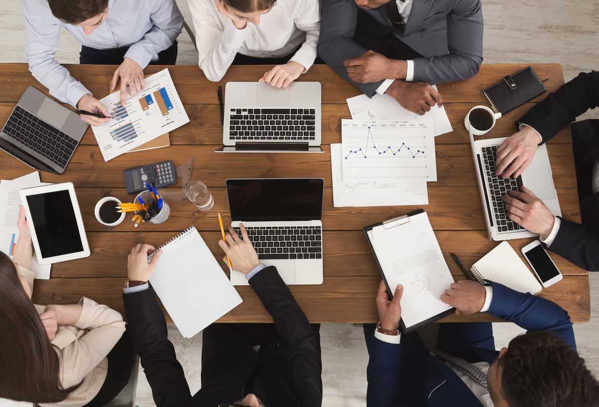 Aerial view of a desk with people working around it. Job vacancies took a small decrease in 2022, but remained high as compared to yearly trends.