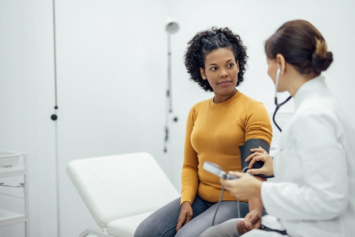 Doctor measuring person's blood pressure