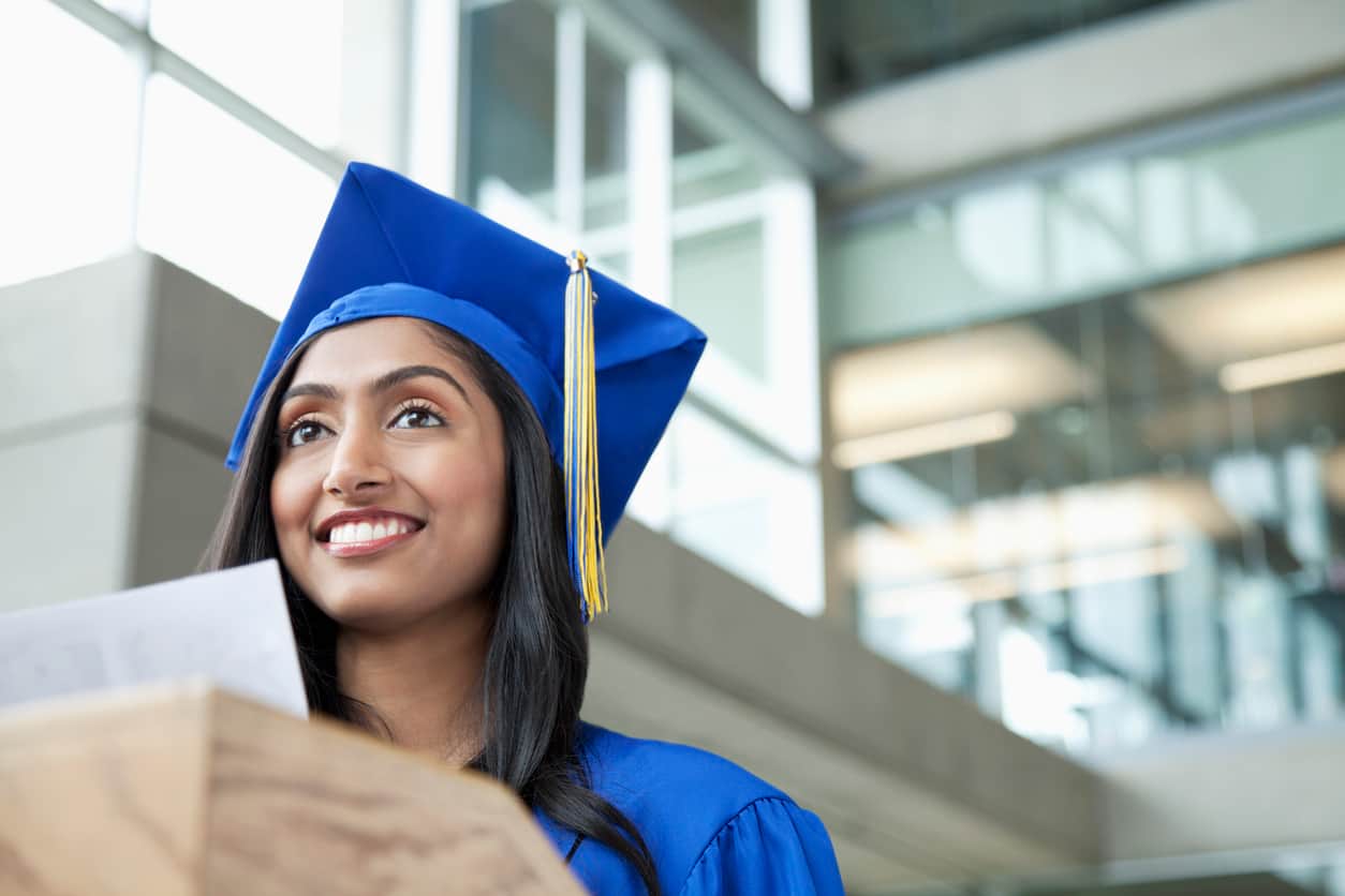 A woman in graduation robes. Canada boasts the most educated workforce in the G7, thanks in large part to new and recent immigrants.