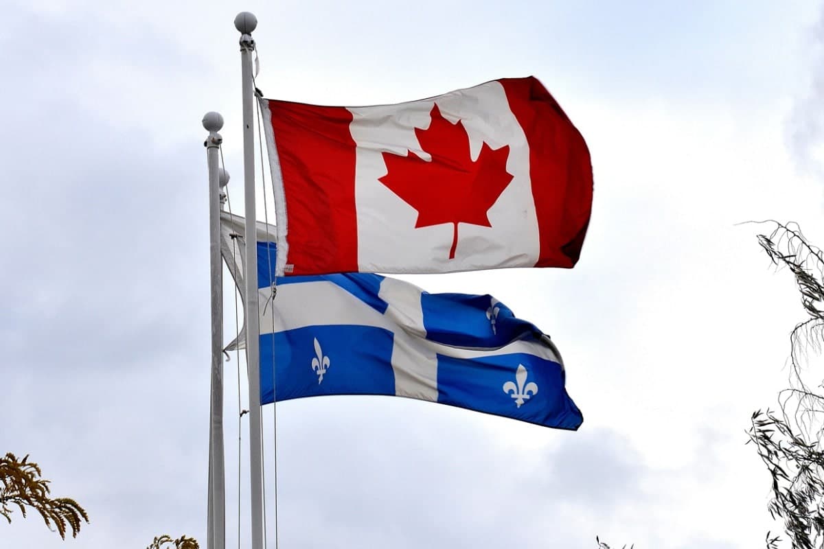canada flag flying above quebec flag
