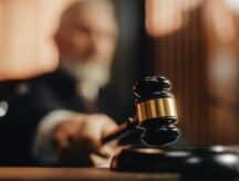Court of Law and Justice Trial Session: Imparcial Honorable Judge Pronouncing Sentence, striking Gavel. Focus on Mallet, Hammer.