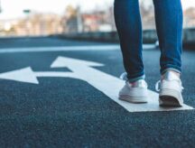 A person walking on a path with two different options.