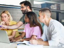 teacher helping teenager students at College, learning technology and science in preparatory course for university