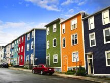A row of colourful houses in the hear of Newfoundland and Labrador on a rainy day.