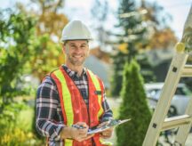 A trade worker wearing a hard hat and protective gear.