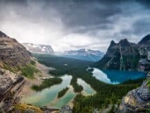 A scenic view of the mountains and the lakes on an overcast summer day.