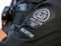 A close-up reveals a Calgary Police badge