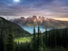 A long shot of Banff with a lake in the foreground and a mountain in the background.