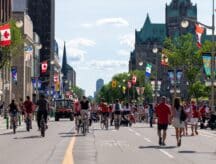 A crowded street with Canadian flags