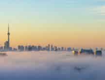 A clear view of toronto skyline with clouds