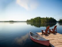 Chairs on a dock next to Muskoka Lake