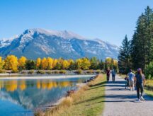 People walking along the Bow River Trail in Canmore, Alberta, in Autumn.