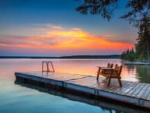 A photo of a pier on a clear lake in manitoba