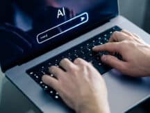A person typing a prompt on a keyboard