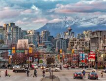 A shot of downtown Vancouver with mountains visible in the background.