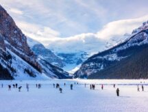 A group of people skating at frozen Lake Louise in Victoria