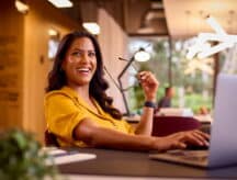A happy worker at their office desk.