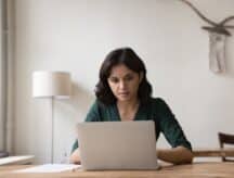 A woman looks up the latest IRCC processing times.